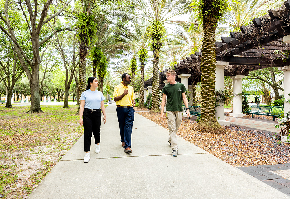 three students walk on campus